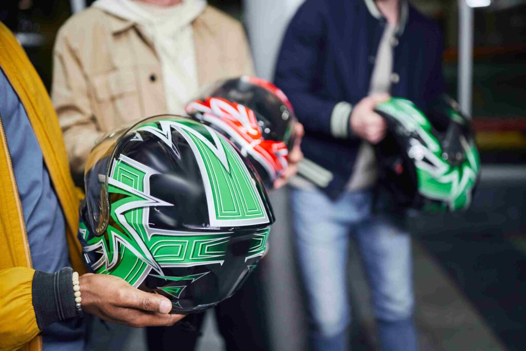 Image of 3 people holding helmet