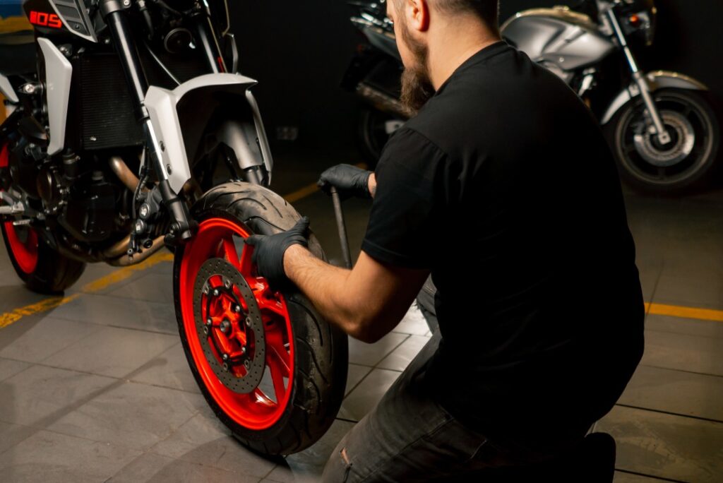 Image of a person checking pressure leakage of bike