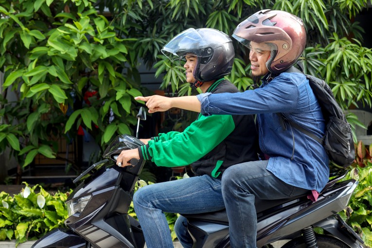 Image of a Biker and It's Pillion Communicating