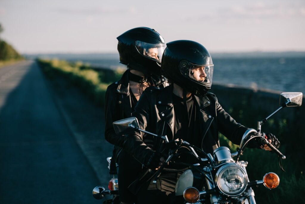 Image of a couple of biker in helmet on a bike